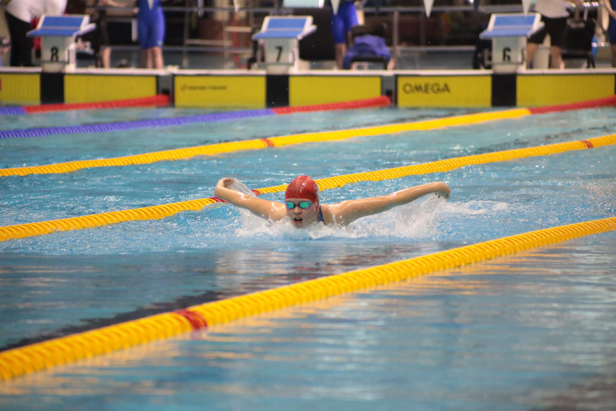 Suki Sowden swimming butterfly in a race lane